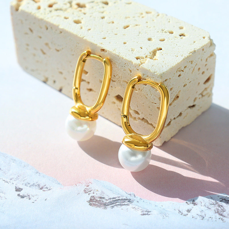 Geometric pearl earrings worn
